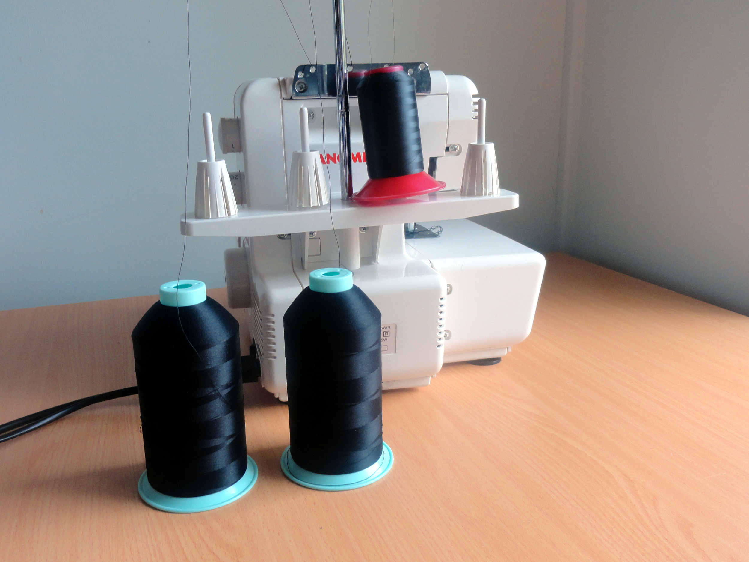 Overlocker Threads on Table Behind Overlocker