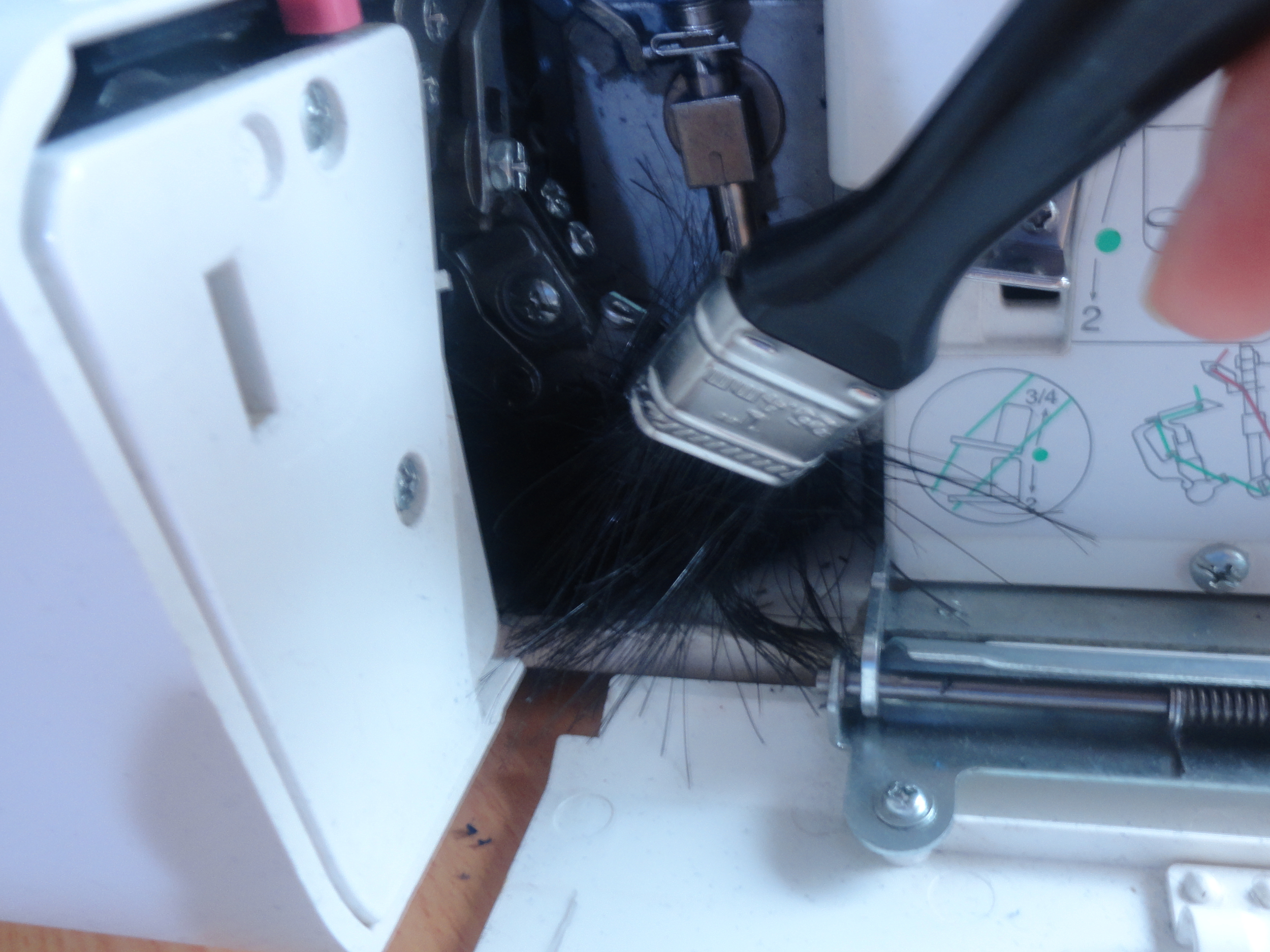 Cleaning behind looper flap of Janome MyLock 644D Overlocker